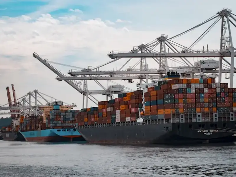 Shipping containers stacked at a UK port awaiting customs clearance